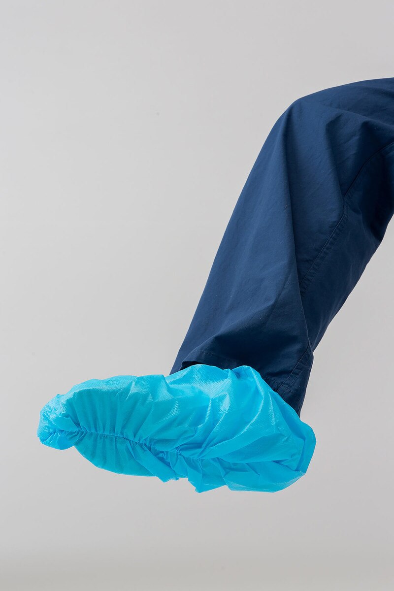 Side view of blue 16-inch non-sterile disposable shoe cover showing the elastic opening and sole