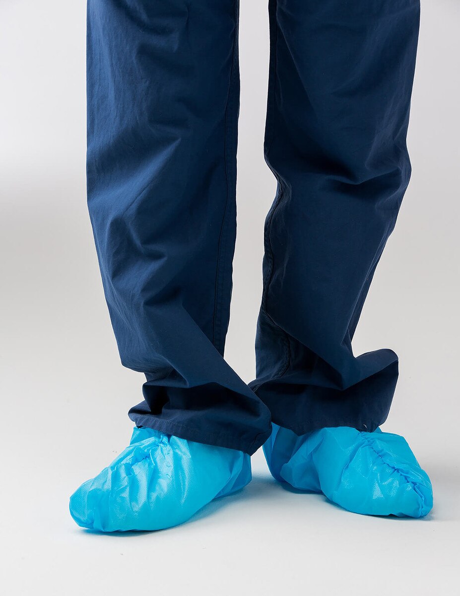 Front view of blue 16-inch non-sterile disposable shoe covers worn over shoes