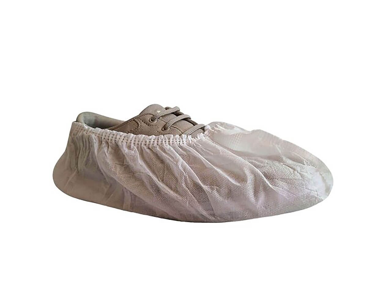Side view of a white International Enviroguard XL SMS shoe cover worn over a lace-up shoe