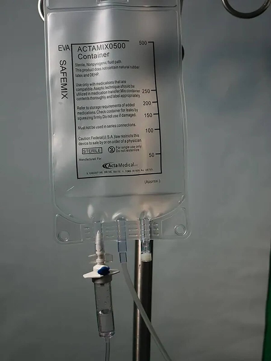 ACTA Medical ACTAMIX0500 500 mL three-port EVA IV bag hanging on an IV pole with administration tubing