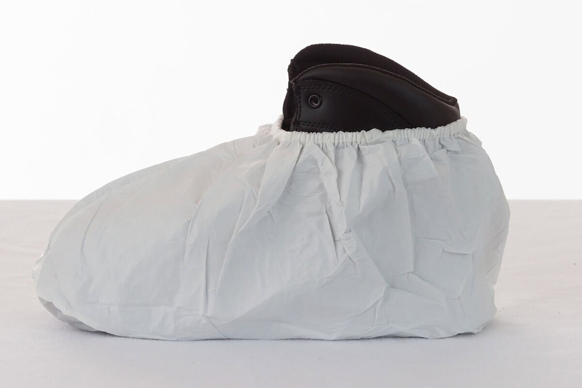 Side view of a white International Enviroguard CE1110 sterile cleanroom shoe cover with an elastic ankle opening