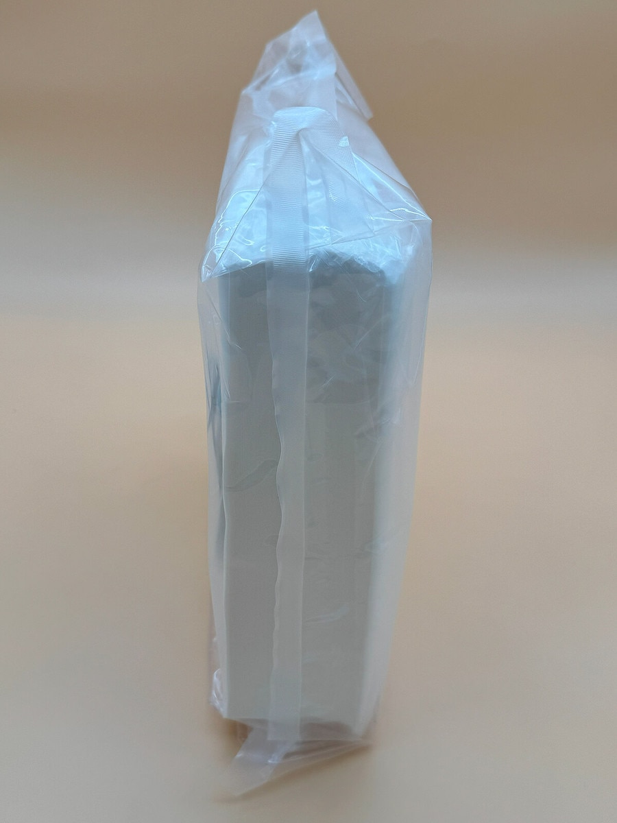 Side view of AstroWipe wipe bundle sealed fully inside clear plastic sterile packaging