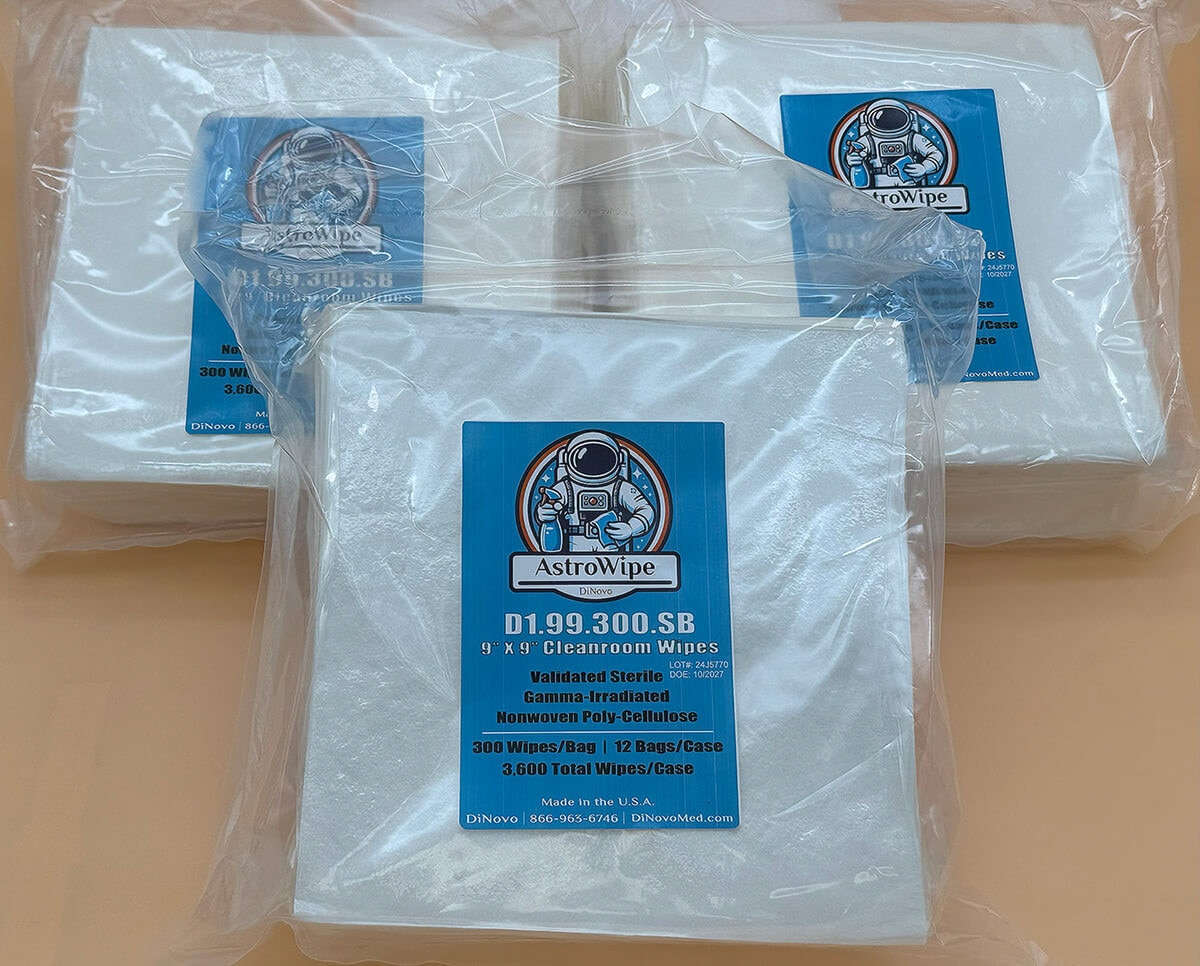 Three full packs of AstroWipe cleanroom wipes stacked together, each individually sealed with blue product labels