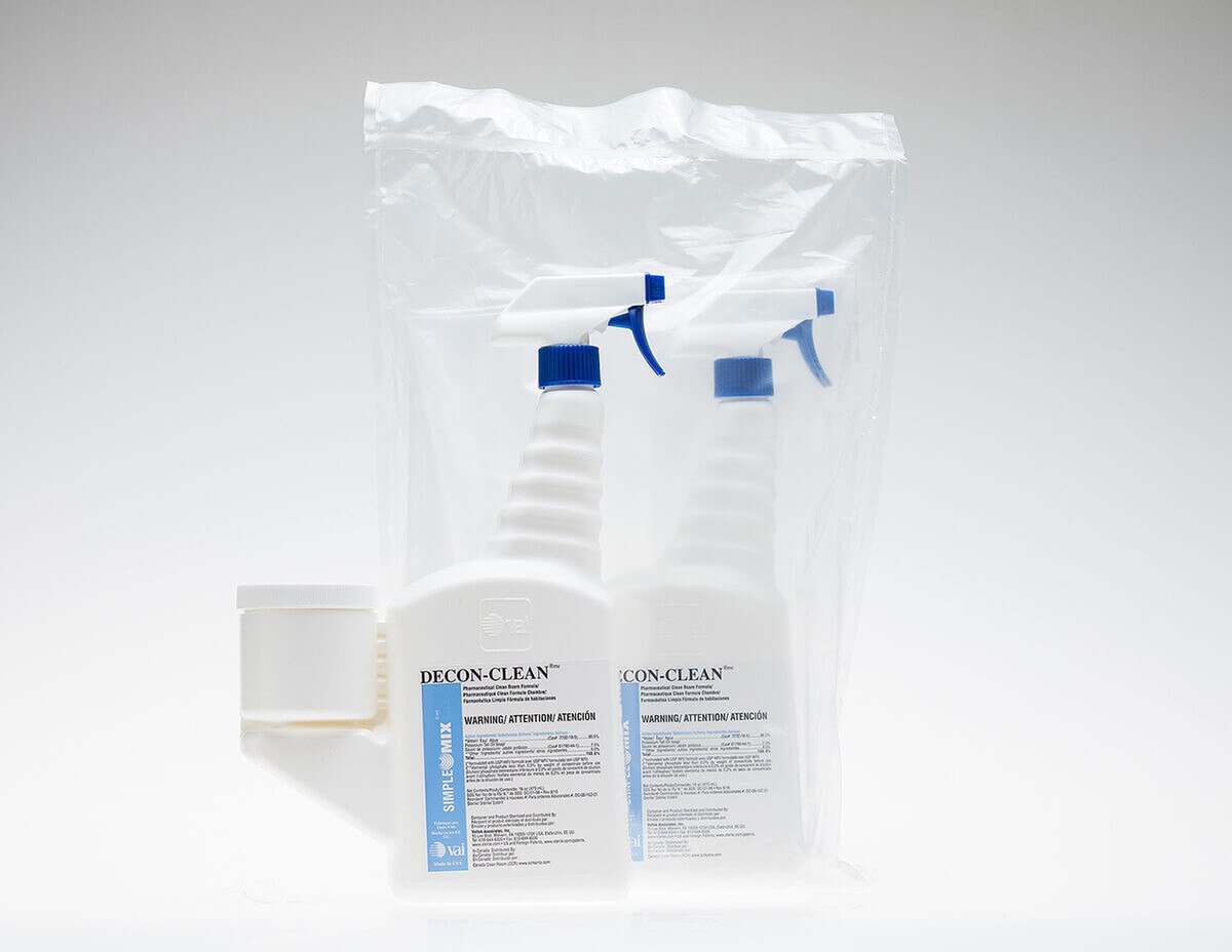 Two DECON-CLEAN trigger spray bottles shown side-by-side, secured inside a clear protective overbag.