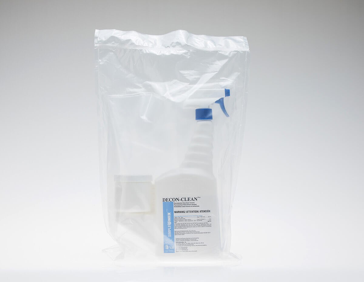 Single DECON-CLEAN trigger spray bottle inside clear protective overbag, front-label fully visible through packaging.