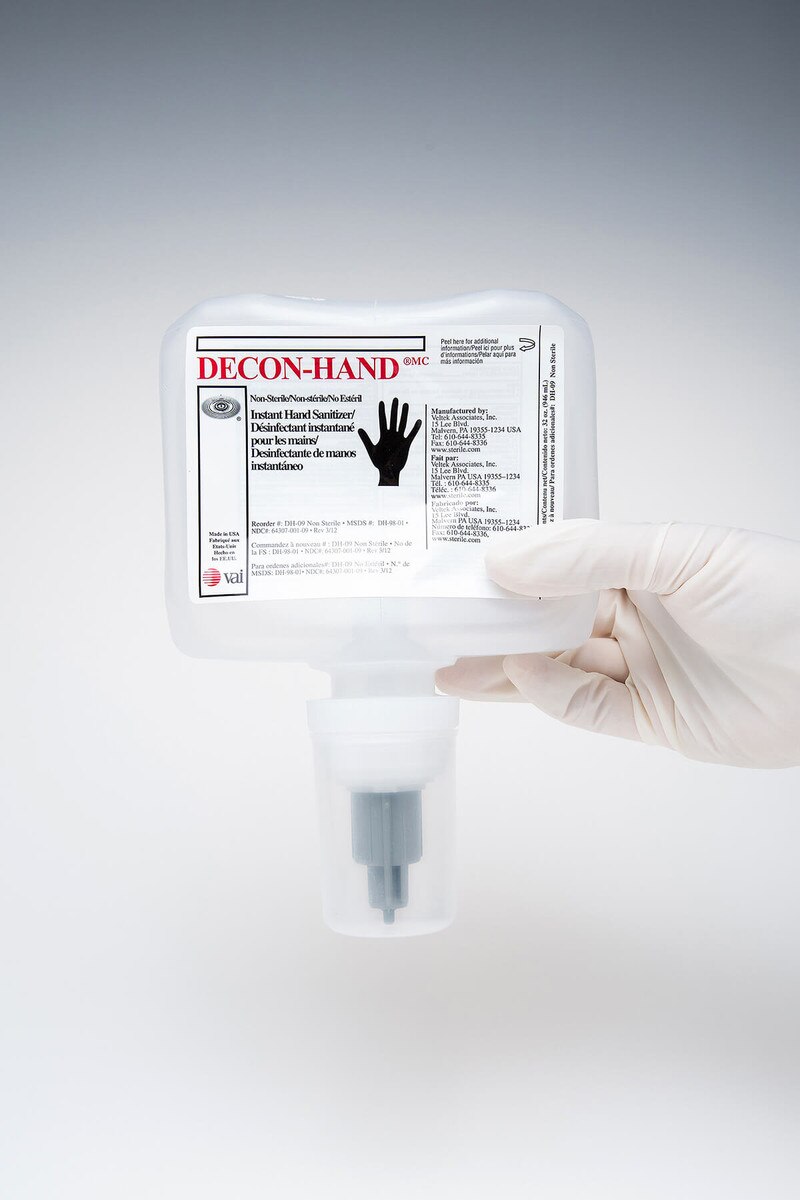 DECON-HAND ASEPTI-CLEANSE ethanol-based sanitizer refill pouch with attached dispensing nozzle, held upright for product visibility.