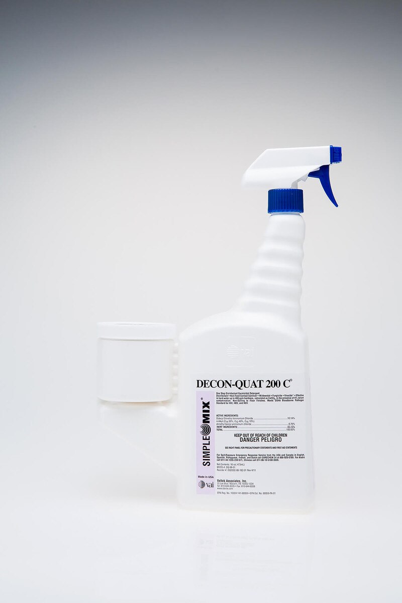 Sterile DECON-QUAT 200C 16oz trigger spray bottle standing upright on a clean white background, showing the product label, blue spray trigger, and attached white measuring chamber.