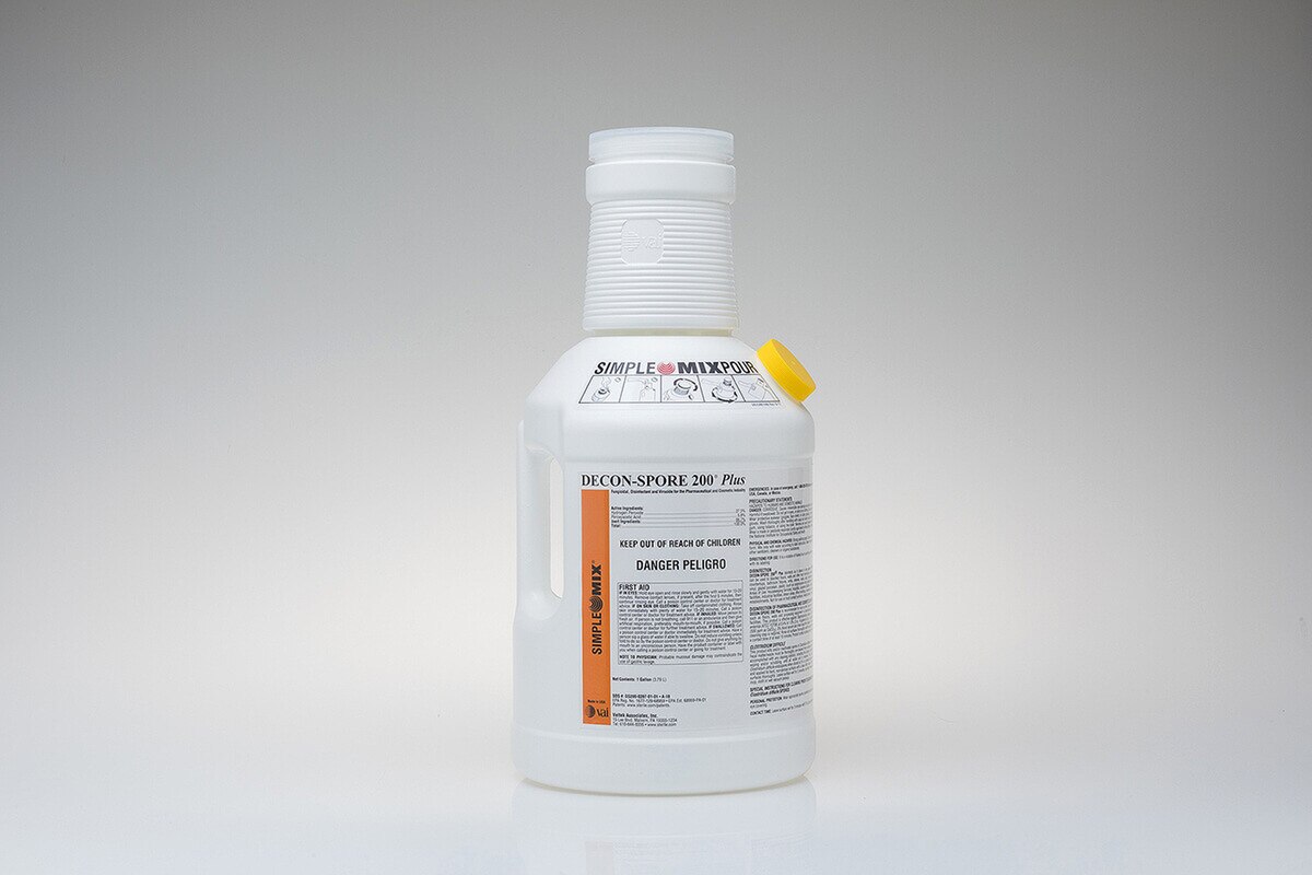 sterile gallon container of decon-spore 200 plus 3 percent with integrated simple mix pour chamber and yellow cap displayed on white background