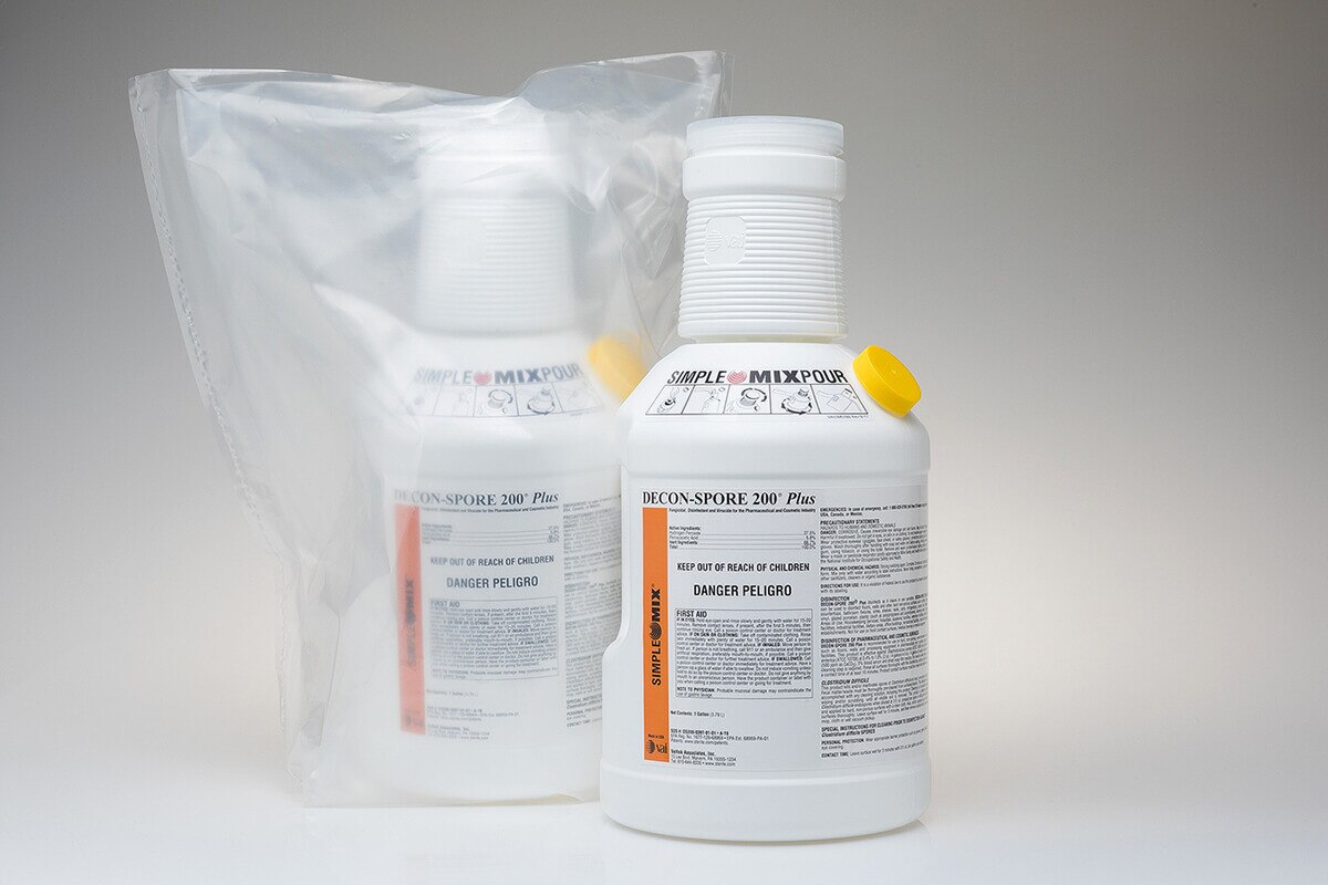 side-by-side view of a bagged decon-spore 200 plus 3 percent gallon container next to an unbagged container on a reflective white surface