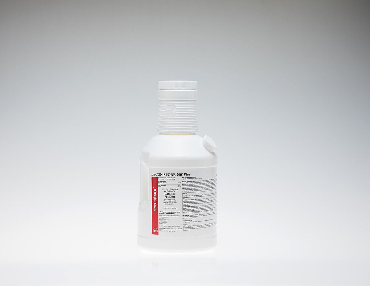 Sterile DECON-SPORE 200 Plus 5% solution bottle positioned upright on a reflective white surface.