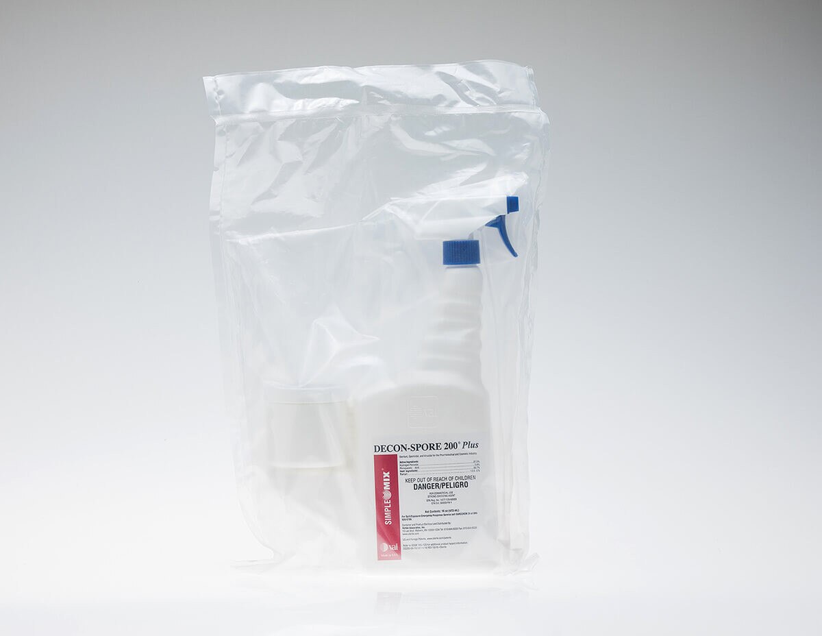 DECON-SPORE 200 Plus 5% trigger spray bottle sealed inside a clear sterile bag with the blue trigger and red label visible through the plastic.