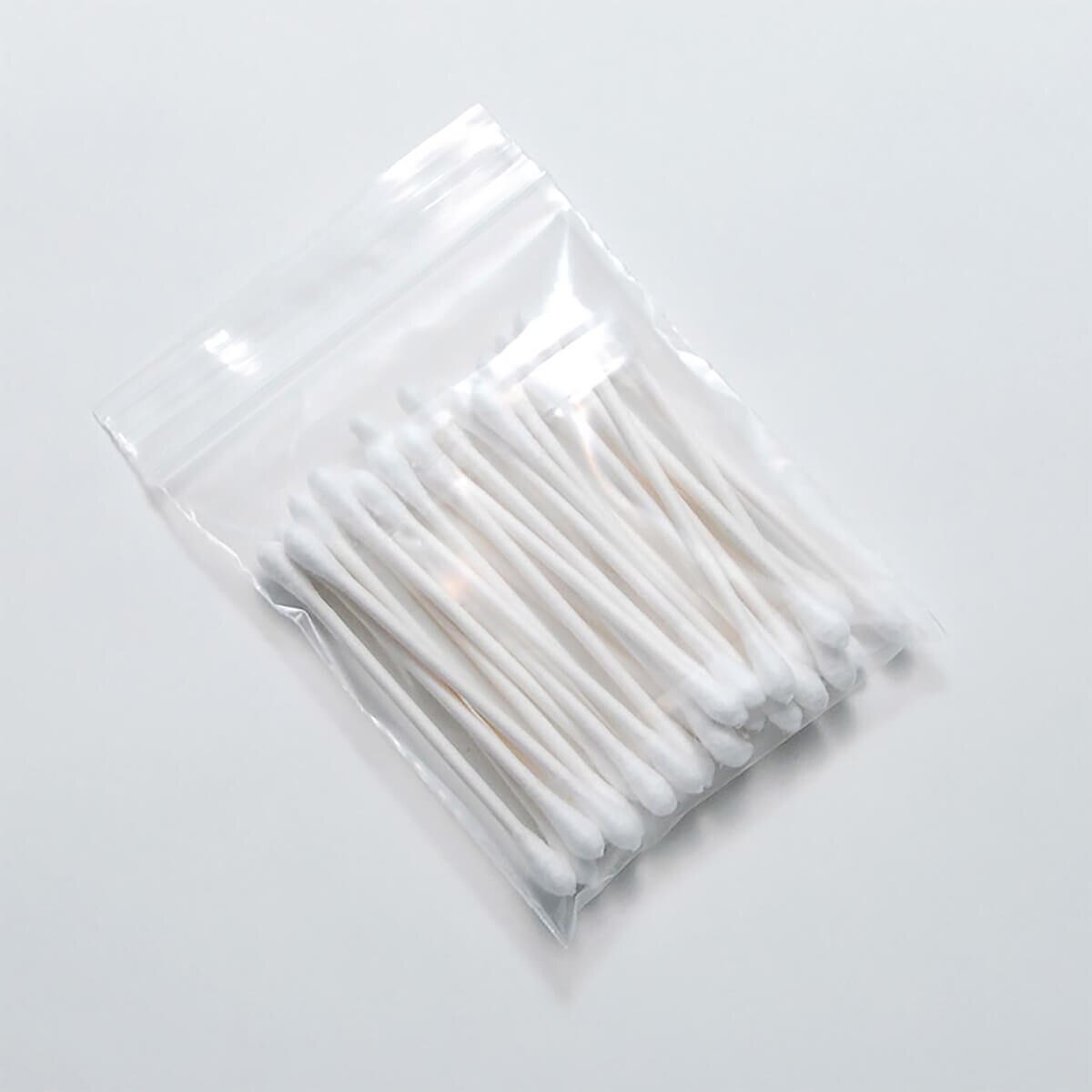 LK clear 2 mil single-track reclosable zipper bag holding cotton swabs