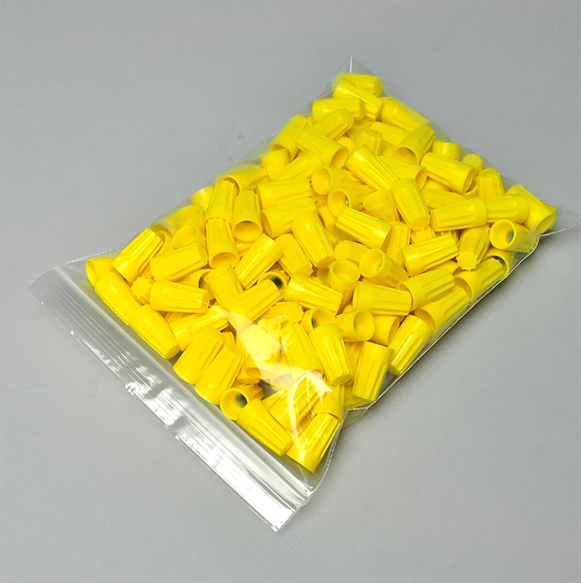 LK clear 2 mil single-track reclosable zipper bag holding yellow wire connectors
