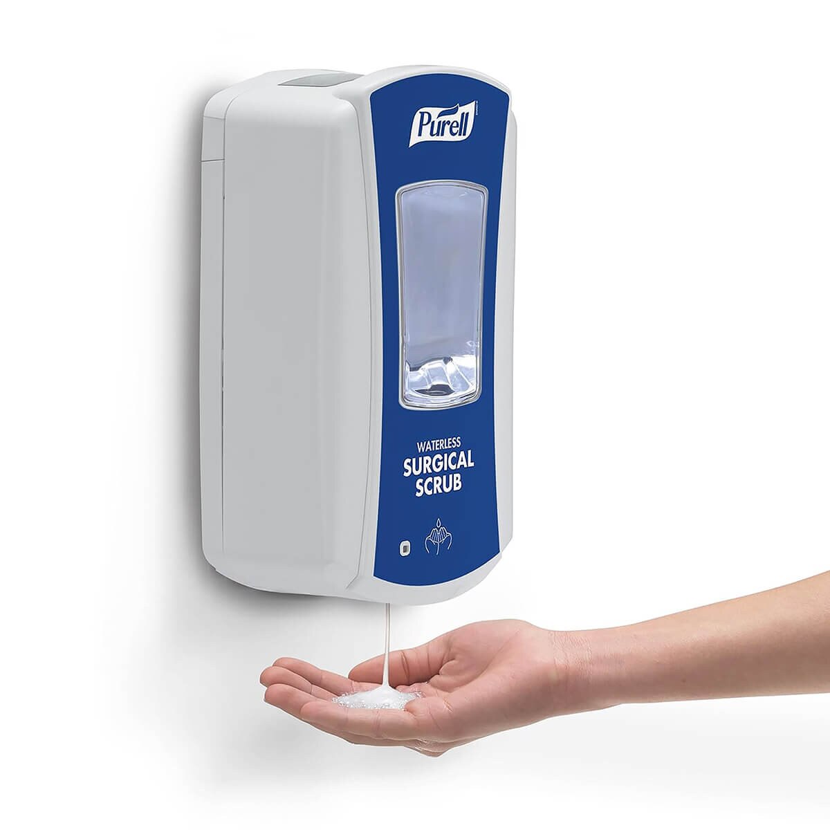 Wall-mounted PURELL LTX-12 surgical scrub dispenser dispensing foam into an open hand, demonstrating touch-free operation.
