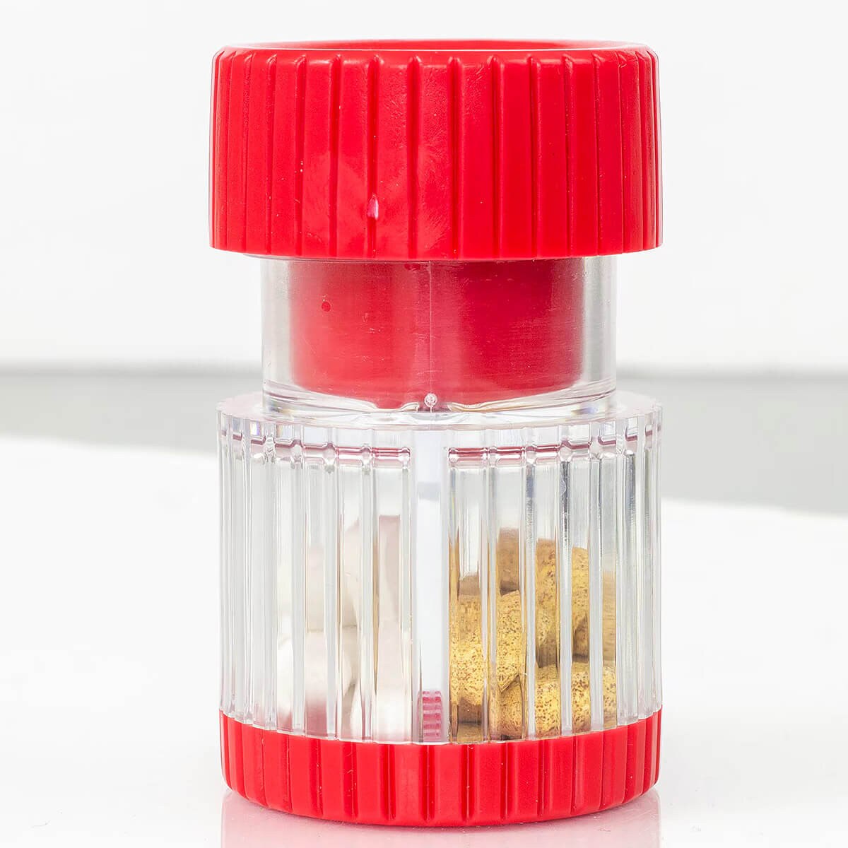HealthSmart red and clear pill crusher with tablets inside the divided storage compartment