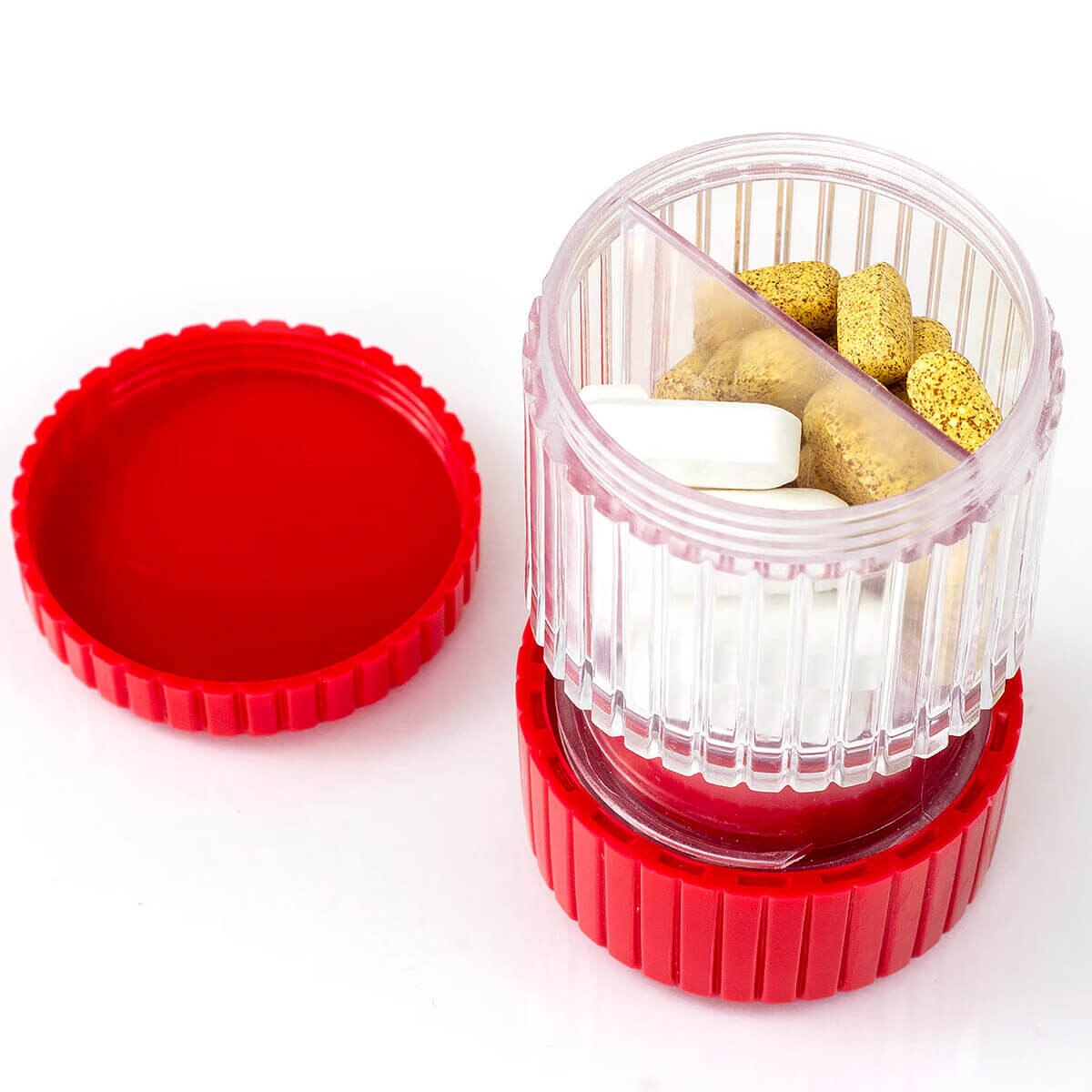Open HealthSmart pill crusher showing the two-section tablet storage compartment with assorted pills