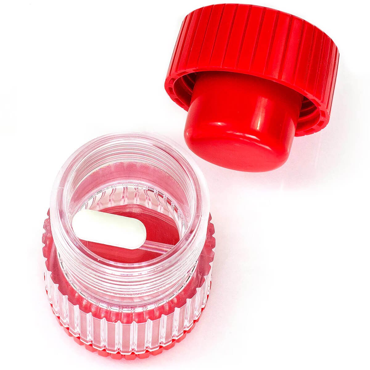 HealthSmart hand-operated pill crusher with red crushing cap removed and tablet inside the clear chamber
