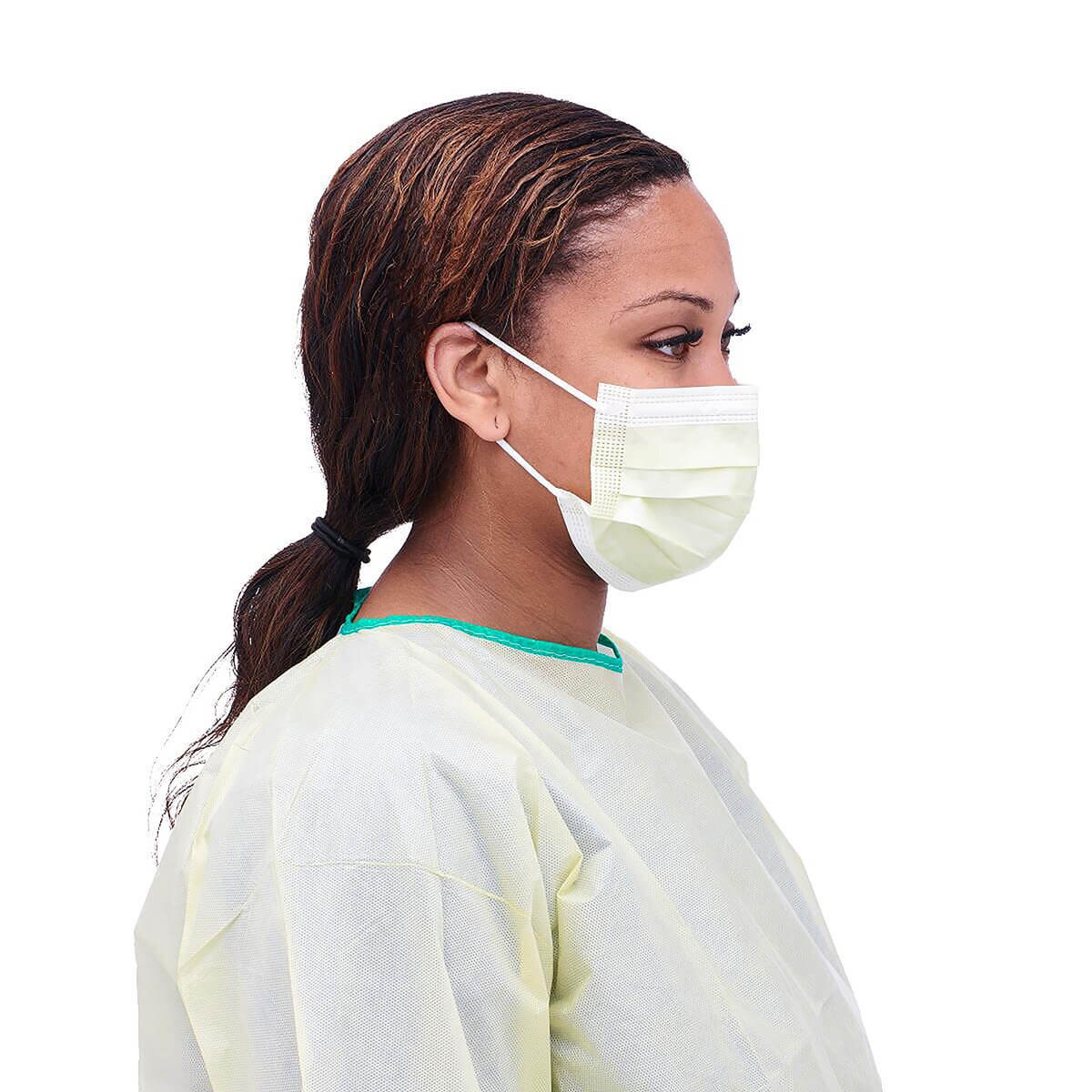 Healthcare worker wearing a Medline Level 1 pleated isolation face mask with ear loops, side view