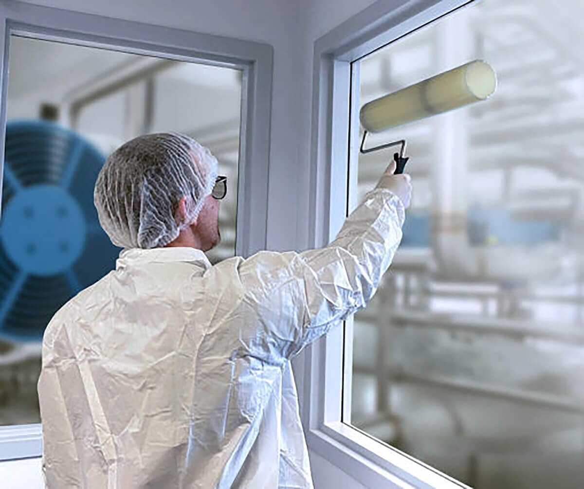 Worker in full cleanroom protective suit using a Film & Foam, Tacky Roller Mop Handle, 18"