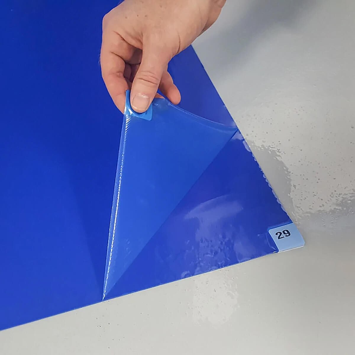 Tacky Traxx, Blue Tacky Mat, Adhesive Back, 24x36 showing peel off adhesive